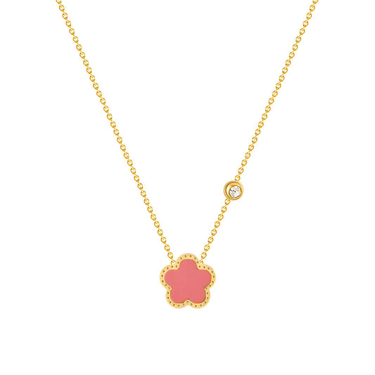 Gold necklace with coral flower pendant and diamond accent, adding elegance to any outfit.
