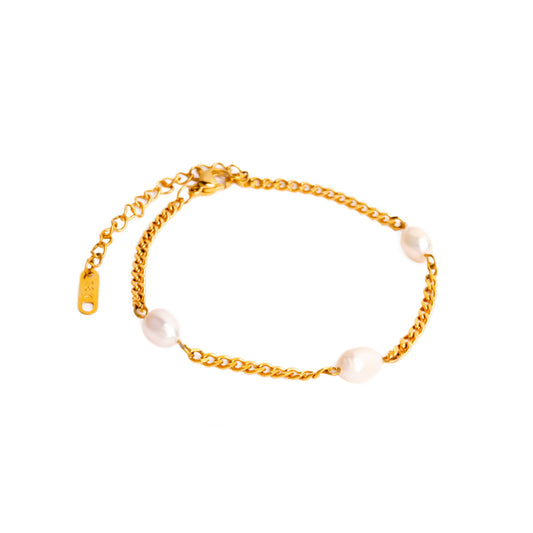 A studio shot on a white background displays the Aura Pearl Bracelet. This gold-toned bracelet features a delicate chain with three irregularly shaped white pearls interspersed along its length, along with a clasp and extender chain.