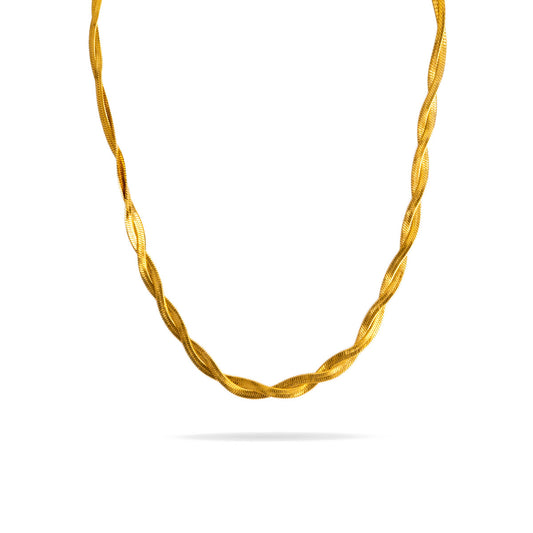 A studio shot on a pristine white background displays the Lumina Herringbone Twist Necklace. The gold-toned necklace hangs and forms a gentle curve, showcasing its design where two flat herringbone chains are elegantly twisted together.