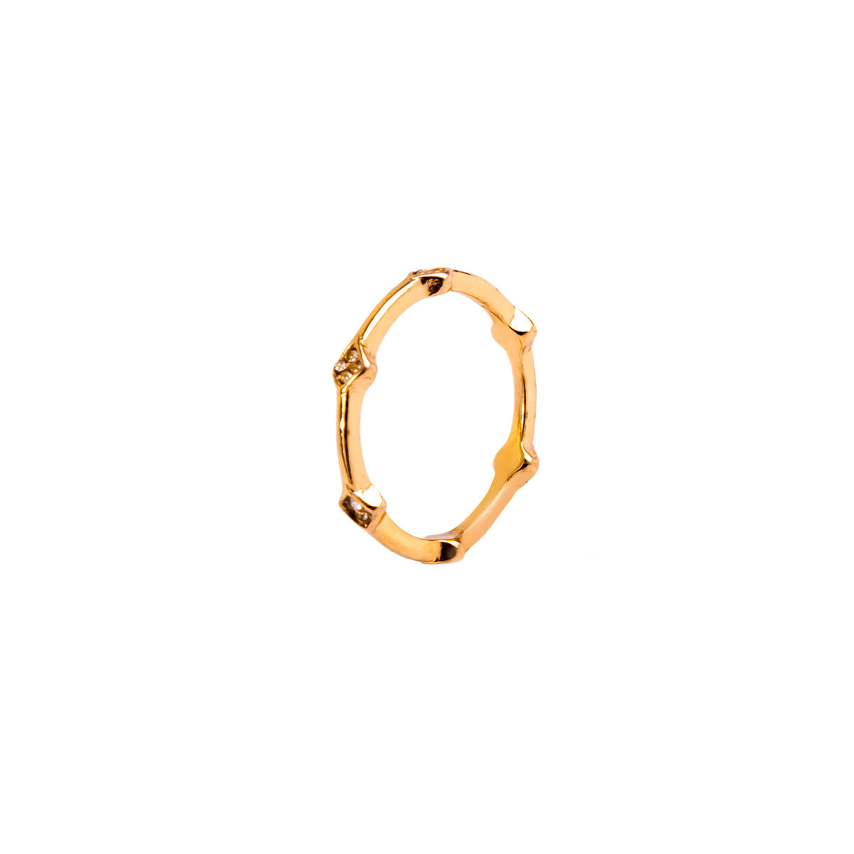 A studio shot on a pristine white background displays the Amara Bamboo Ring. This gold-toned ring has a thin, segmented band resembling bamboo, with several of the segments set with tiny, brilliant gemstones.