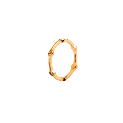 A studio shot on a pristine white background displays the Amara Bamboo Ring. This gold-toned ring has a thin, segmented band resembling bamboo, with several of the segments set with tiny, brilliant gemstones.