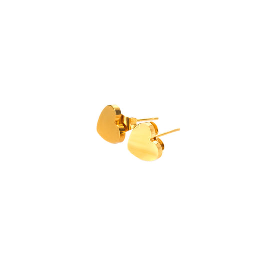 A studio shot on a bright white background shows a pair of Amara Heart Studs. Each gold-toned earring is a small, solid, and highly polished heart with a classic post backing.