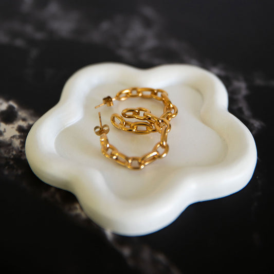  Aurora Glow gold chain-link hoop earrings displayed on a soft white ceramic dish – Delta Jewel