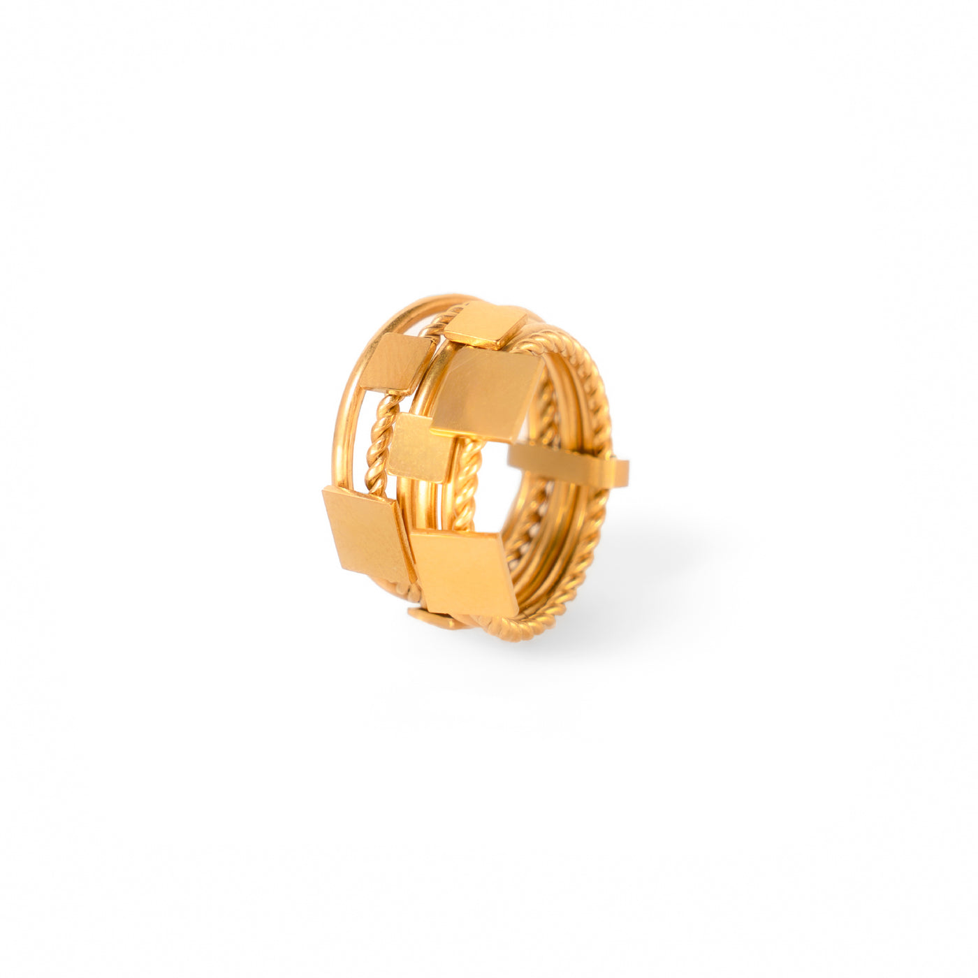 A studio shot on a white background displays the Aurora Stacking Rings. This gold-toned ring features a bold, multi-band design that includes smooth bands, a rope-like twisted band, and a central section of flat, square-shaped geometric elements.