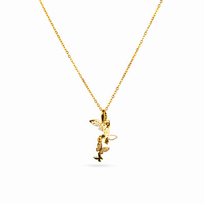 A studio shot on a white background displays the Celeste Butterfly Necklace. This gold-toned necklace has a fine chain and a vertical arrangement of four butterfly pendants, two of which are detailed with sparkling clear gemstones.