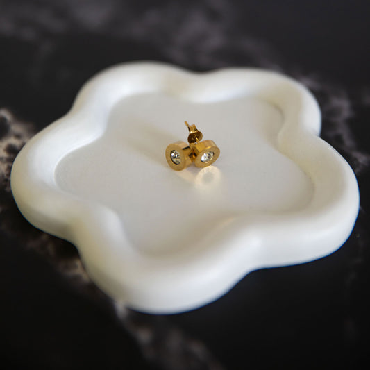 Celeste Inspired gold stud earrings with clear crystal center on a white ceramic tray – Delta Jewel