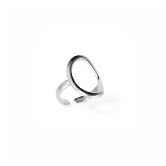 A studio shot on a pristine white background displays the Celeste Teardrop Ring. This silver-toned ring features a polished, fluid open teardrop shape on top, with an open-ended band for adjustability.