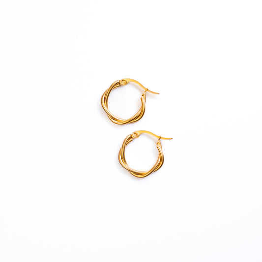 A top-down studio shot on a bright white background displays a pair of Elara Twist Earrings. Each earring is a small, polished gold-toned hoop with a distinctive twisted design, creating an appealing textured look.