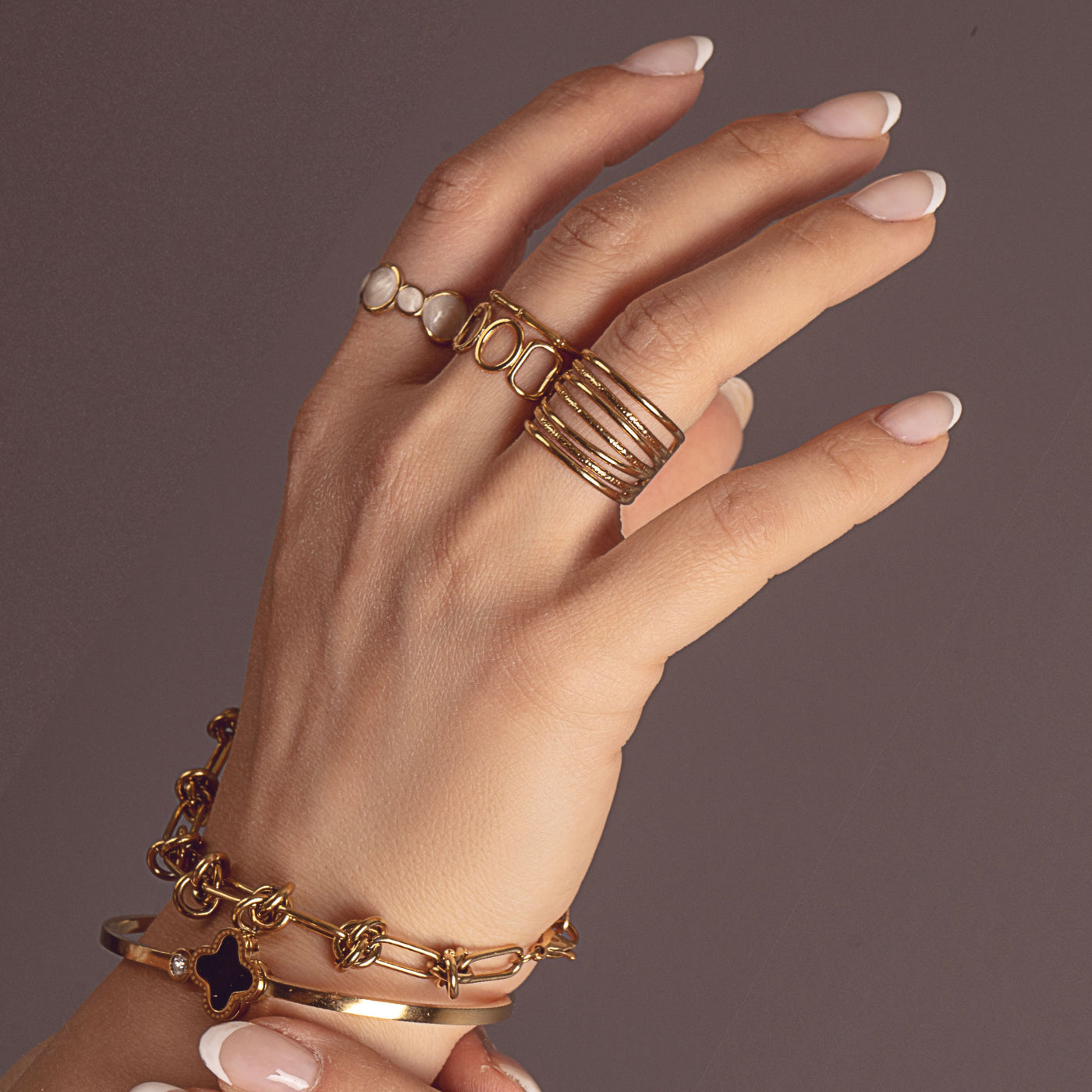Hazel Spark Ring by Delta Jewel, a gold-plated design featuring pearlescent accents, worn on the index finger.