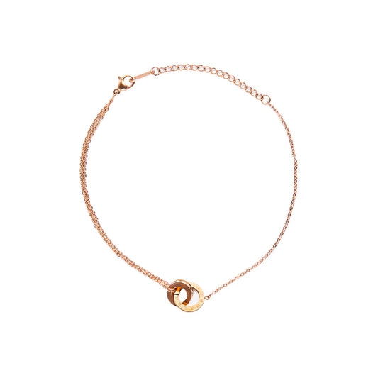 A studio shot on a white background displays the Ivy Radiance Bracelet. The rose gold-toned bracelet's double chain leads to a centerpiece of two interlocking rings, with a lobster clasp and extender chain visible at the top.