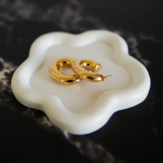  Luna Bliss gold-plated stud earrings displayed on a white ceramic dish – Delta Jewel