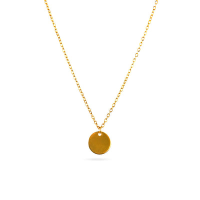 The Luna Disc Necklace is displayed in a studio shot against a bright white background. This elegant gold-toned necklace features a fine chain that suspends a perfectly round, flat, and polished disc pendant.