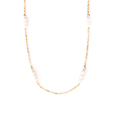 A studio shot on a pristine white background showcases the Lyra Pearl Chain Necklace. This gold-toned necklace features a delicate chain with small, irregularly shaped white pearls spaced along its length, forming a gentle U-shape.