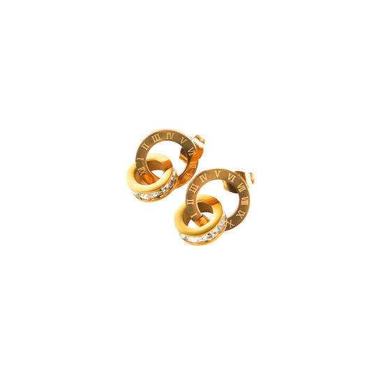 A studio shot on a pristine white background displays a pair of Roma Timeless Hoops. These gold-toned stud earrings feature two interconnected circles, one with Roman numerals and the other adorned with sparkling clear stones.